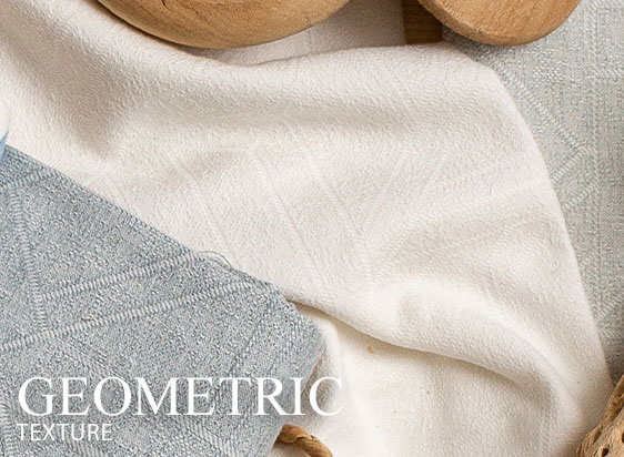 Soft blue and ivory fabrics with dimensional geometric weave